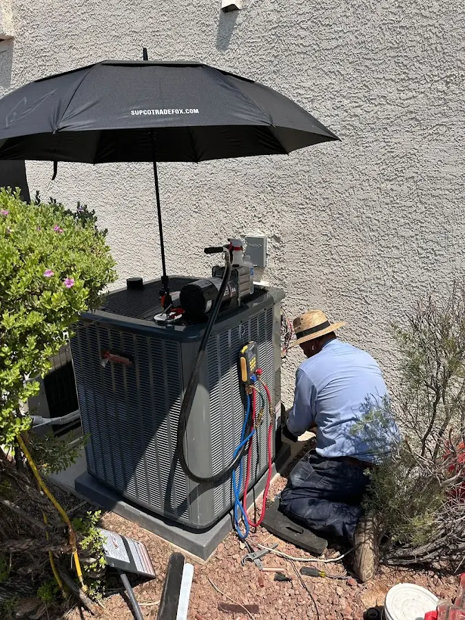 HVAC technician performing outdoor AC maintenance in Poinciana